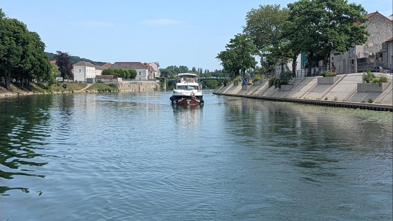 Le yacht Le Stern remonte vers le port entre les quais de La Ferté-sous-Jouarre